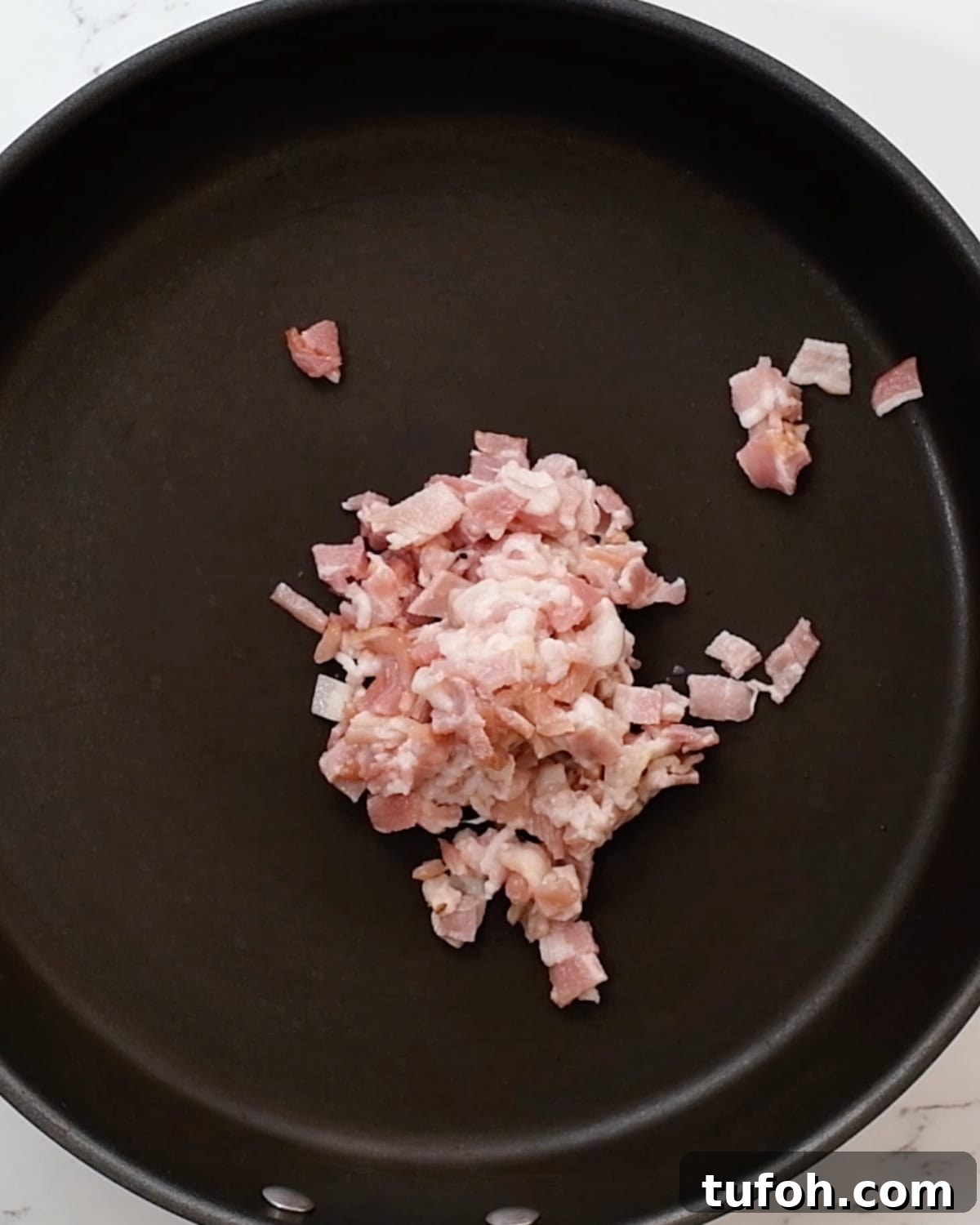 bacon in a fry pan before cooking