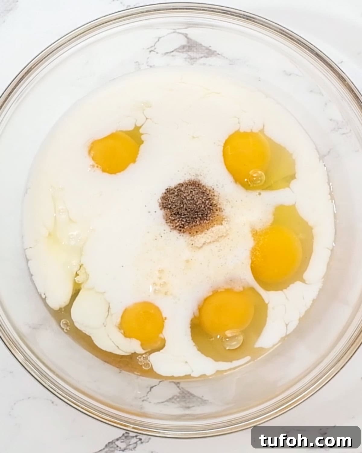 Hash Brown Crust Quiche filling ingredients in a bowl before whisking