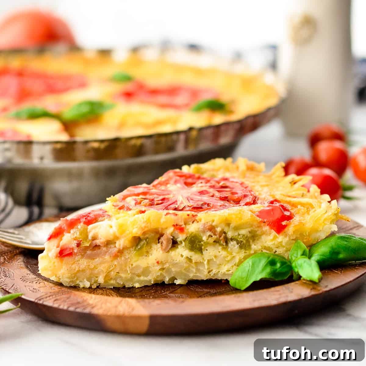 a slice of hash brown quiche on a plate