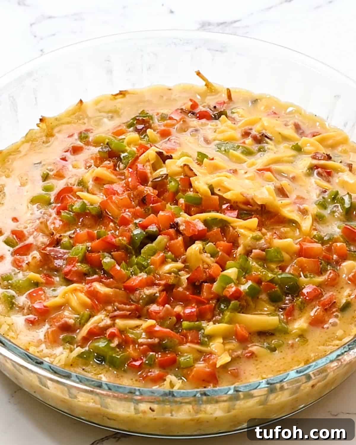 Hash Brown Crust Quiche filling poured into hash brown crust