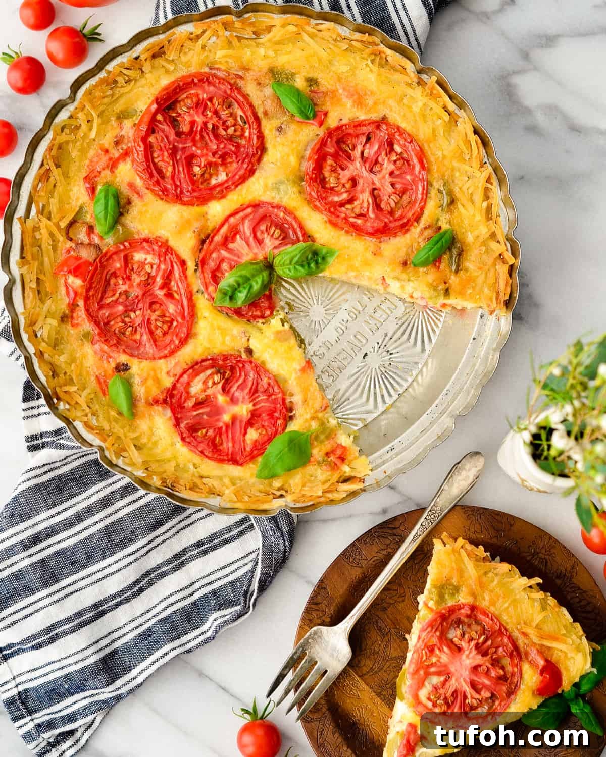 Overhead view of Gluten-Free Hash Brown Quiche with one slice cut out and on a plate next to it