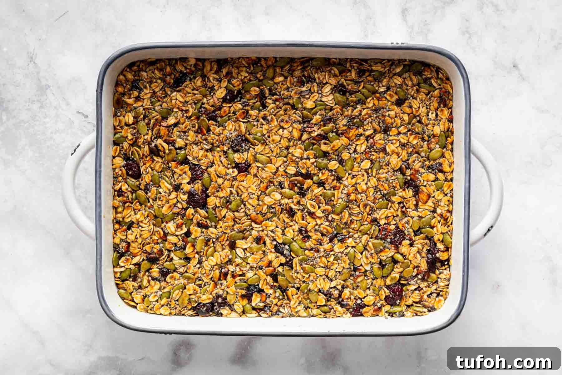 Baking tray packed with no bake granola bars on kitchen counter.