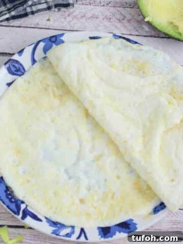 Egg white wraps on a blue flowered plate.
