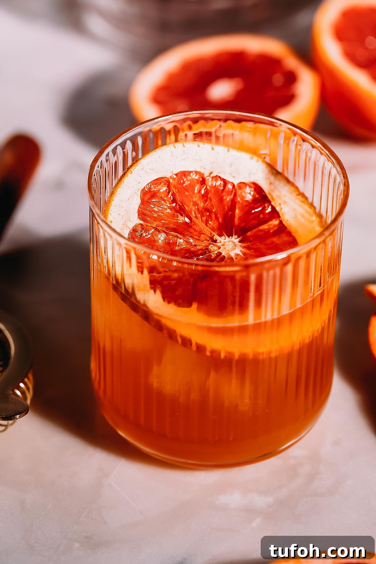 Brown derby cocktail garnished with a grapefruit slice.