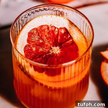 Overhead shot of a grapefruit garnish in a cocktail glass.