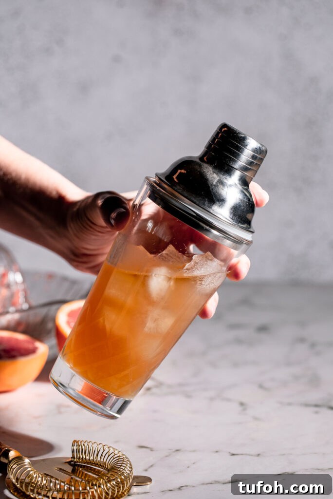 Cocktail shaker being held to shake.